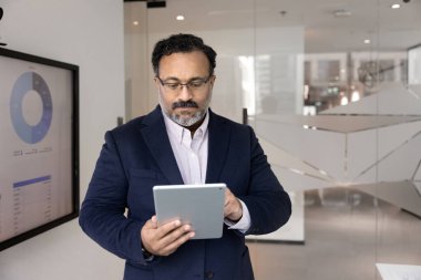 İş planlaması ve teknoloji. Yetişkin işadamı, ekranda mali istatistik verileriyle yönetim kurulundaki pazar analizi tahminleri üzerine çevrimiçi çalışmaya odaklanmış durumda. Boşluğu kopyala