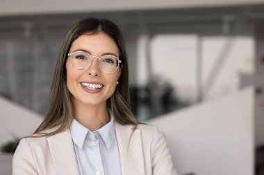 Mutlu başarılı, güzel İspanyol iş kadını, zarif gözlüklü, fotokopi çekilen profesyonel portre için poz veren, mükemmel dişlek gülüşlü kameraya bakan.
