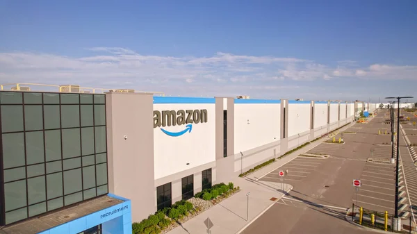 stock image Toronto, Ontario, Canada - September 11, 2022: Aerial view of Amazon logo brand name and trademark at distribution center warehouse Entrance. Large storage facility and office headquarter.