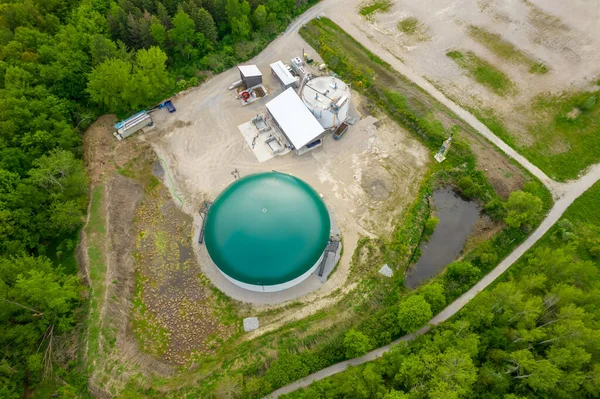 Biogas plant and farm in park or green space in Toronto, Canada. Renewable energy from biomass such as organic food waste and zoo manure. Storage tank for biogas and power produce.