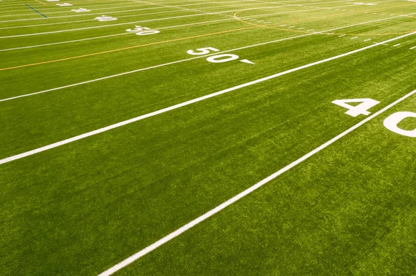 View of empty soccer field without players. Football field with grass and white paint lines and marks. Sports soccer and football with green surface. Recreational activity.