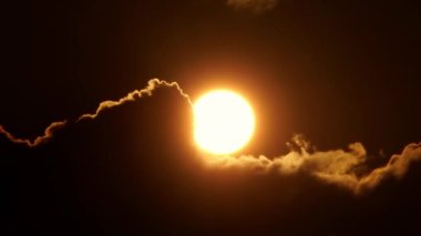 Sinema güneşi kırmızı sarı ve turuncu gökyüzünde batıyor. Sıcak yaz atmosferi sıcak hava dalgasında. Sarı güneş destansı altın saat hızında batıyor. Büyük yuvarlak güneş diskini kapat.