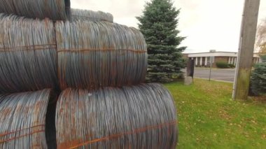 Metal corroded steel bars or rods in coils. Reinforcement for concrete construction sites. Steel wire rolls in construction site. Rolled steel stacked together in group of coiled wire.