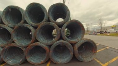 Metal corroded steel bars or rods in coils. Reinforcement for concrete construction sites. Steel wire rolls in construction site. Rolled steel stacked together in group of coiled wire.
