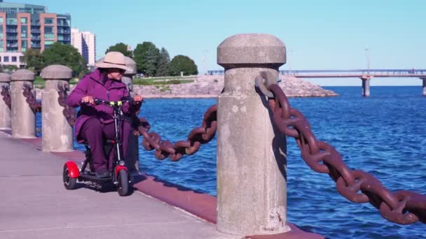 Woman Who Has Disability Motorized Wheelchair Mobility Scooter Driving Recreational — Videoclip de stoc