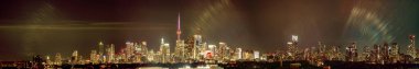Toronto skyline at night with buildings street lights. Toronto, Ontario, Canada. Down town city skyline and panorama with urban areas. Sky with lights leaks.
