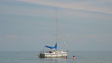 Sailing ship yacht with sails at opened waters. Sailboat at summer. Boat or yacht in calm water. Scarborough Bluffs. Toronto, Ontario, Canada - July 15, 2022