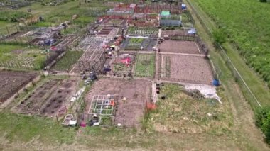 Homesteading life style and self-sufficient food preserving concept. Modern permaculture in the city neighbourhoods with small farms and urban family gardens. Aerial view.