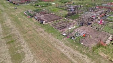 Aerial view of the community based modern urban farming and organic family gardens with various vegetables, fruits and plants. Cultivation of fresh produce and Homestead horticulture.,