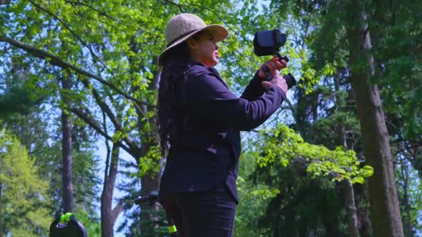 独木女徒步旅行者和电影制作人记录了自然界美丽风景的录像 女性旅行者拍摄内容与数码相机平台设置 室外自由职业和业余爱好 社会内容 — 图库视频影像