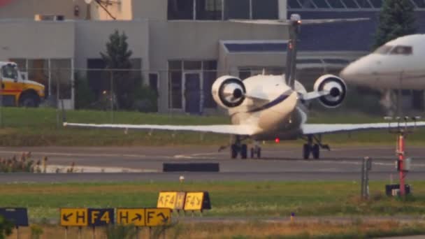 小型の2機のボンバルディアガルフストリームジェット機の閉鎖 シマーヘイズで空港駐車場でナビゲート トロント オンタリオ カナダ 2022 — ストック動画