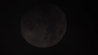 Geceleri yoğun kara bulutlar arasında uçan ay. Büyük dolunay zamanı kara bulutların içinde kayboluyor. Cadılar Bayramı cadılığı, atmosferik karanlık gece gökyüzü mistik gerilim konsepti için ay ışığı..
