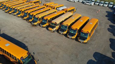 Toronto, Ontario, Canada - September 1, 2022: Row filled with many school bus ready to pick up students to school. Aerial view. Park full of school buses waiting for educational season. 