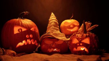 Cadılar Bayramı 'nız kutlu olsun. Cadılar Bayramı balkabaklarının parıldayan yüzleri. Seçici odaklanma. Karanlık arka planda parlayan korkunç Jack O Lantern ruh iblisleri. Geleneksel Cadılar Bayramı sembolü.