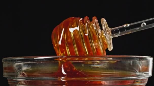 甘い蜂蜜は ガラスカップ プラスチックリサイクルにプラスチック製の蜂蜜スティックダウンフロー 高品質4K映像 — ストック動画
