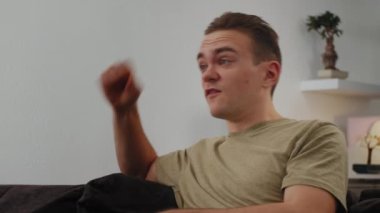 Genç ve çekici bir adam koltuğa oturur ve futbol maçı filmi yönetir, sonuçtan hiç memnun değildir. Yüksek kalite 4k görüntü