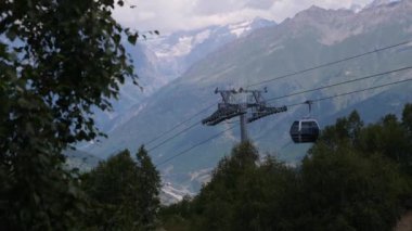 4K teleferik videosu. Büyük kar dağı arka planı, Hatsvali Kablo Araba.