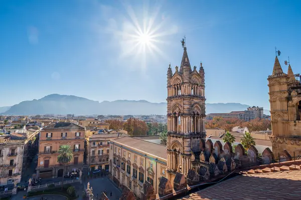 Amidst the bustling city of palermo, the majestic palermo cathedral stands tall with its stone spires reaching towards the sun, overlooking the landscape of sicily and its surrounding mountains