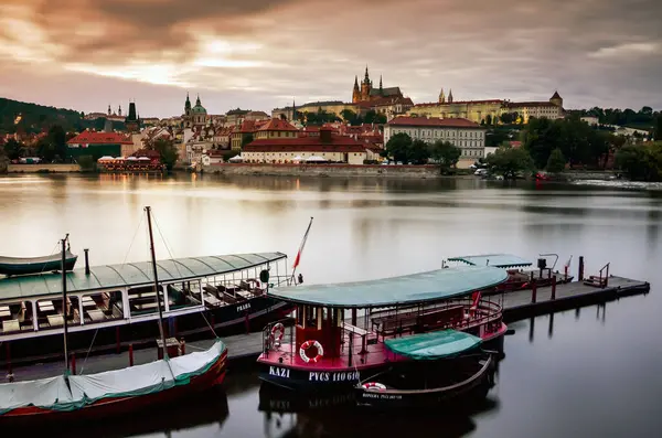 Vltava nehir kıyısından Prag kalesi manzarası, öndeki botlar, alacakaranlıkta, Avrupa