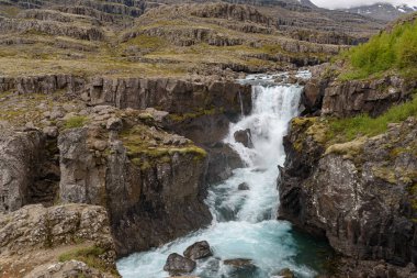 The waterfall Nykurhylsfoss, also known as Sveinsstekksfoss, in southeast Iceland clipart
