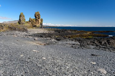 The Londrangar basalt cliff in the Snaefellsnes peninsula in western Iceland clipart
