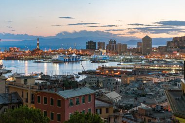 Panoramic view of the harbor of Genoa with Lanterna lighthouse in the background at the dusk. Liguria, Italy