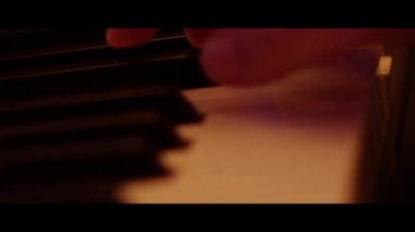 Hands Playing on Piano Keyboard Close Up