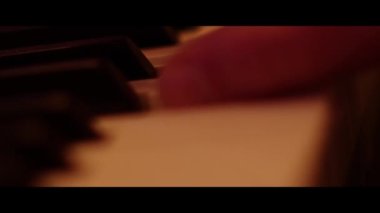 Hands Playing on Piano Keyboard Close Up