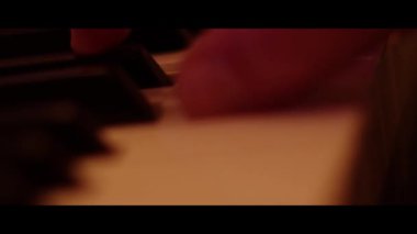 Hands Playing on Piano Keyboard Close Up