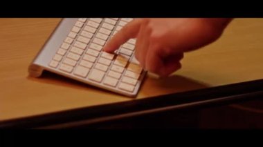 Hand typing on a computer keyboard  close up video recording indoor.