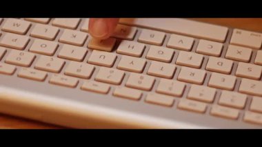 Hand typing on a computer keyboard  close up video recording indoor.