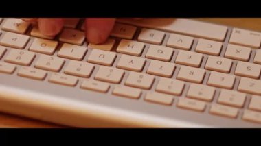Hand typing on a computer keyboard  close up video recording indoor.