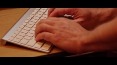 Hand typing on a computer keyboard  close up video recording indoor.