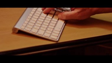 Hand typing on a computer keyboard  close up video recording indoor.