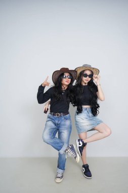 Asyalı genç bayan arkadaşlar güneş gözlükleriyle poz veriyorlar