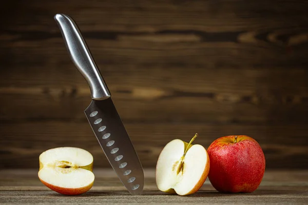 stock image Knife. Stainless steel knife, apple. Chef or butcher knife. Professional equipment on kitchen. Knife for slice fruit, vegetable, meat. One piece of kitchenware. Cookware set. Wooden table background.