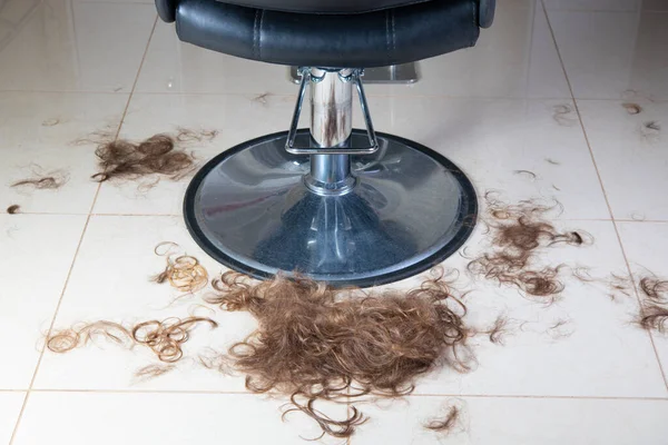 Hair after haircut on the floor. Cut off Hair or Trimming Hair. Barber Salon. Pile or Heap of hair after haircut. Hairdresser salon. Man or Woman haircut. Salon for male or female.