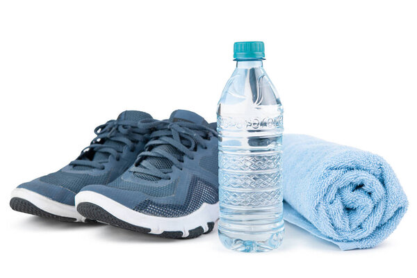 Bottle of water, sport shoes, sneakers or joggers and bleu towel. Concept for gym, fitness. Sport equipment or accessories for training or running. Workout sportswear. Isolated on white background.