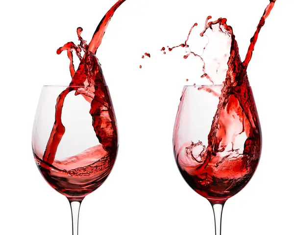 Wine. Glass of red, pink wine. Wine splash in wineglass. Alcohol drink party. Photo good for restaurant, bar. Merlot or Cabernet Sauvignon. Pouring into a glass. Isolated background