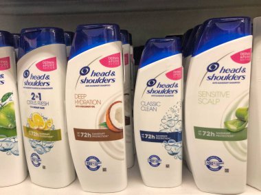 22.01.2023 Ukraine, Kharkiv, a shelf in a supermarket with hair shampoos: Head Shoulders shampoo in hair care products line in supermarket.