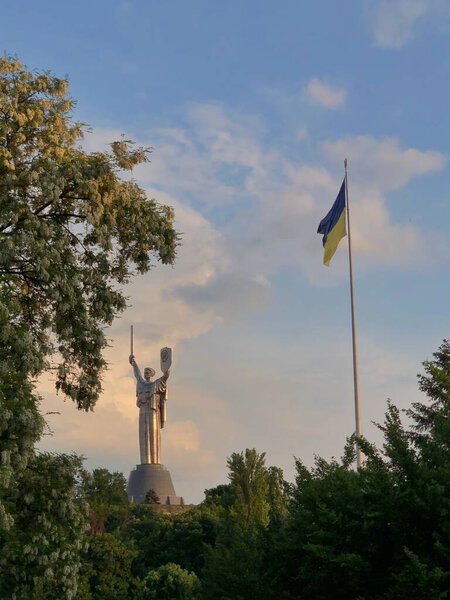 27.05.2023, Ukraine, Kyiv. Historical monument Motherland in Kyiv with Ukrainian yellow-blue flag