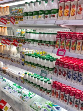 15.07.2023, Ukrayna, Harkov, mandıra ürünleri süpermarket zemininde: büyük bir şişe yoğurt seçimi