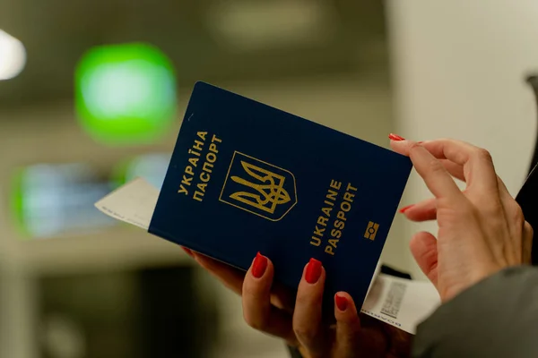 stock image Biometric passport of Ukraine. A woman's hand flips through a passport.