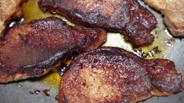 Meat. The meat is fried in a pan.