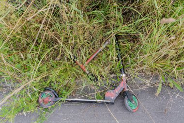 Scooter. The stunt scooter lies on the asphalt.