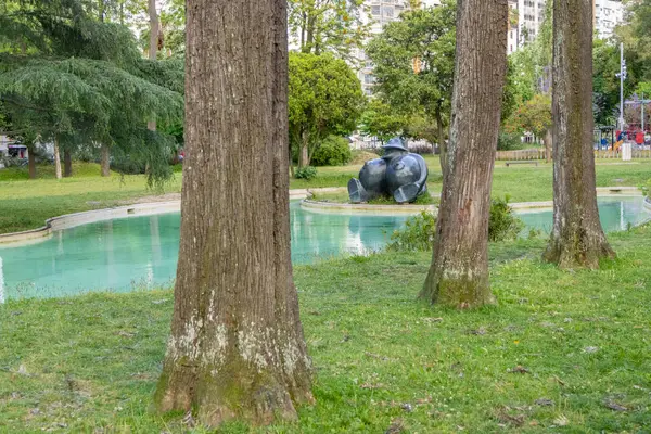 stock image Tranquil view of a garden with trees, pond, and modern sculpture at garden mario soares in lisbon, portugal