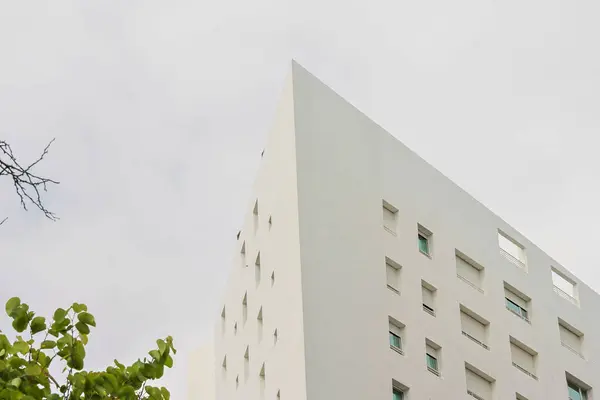 Stock image Contemporary building in lisbon's nations' park portrays minimalism and innovative design against a cloudy sky