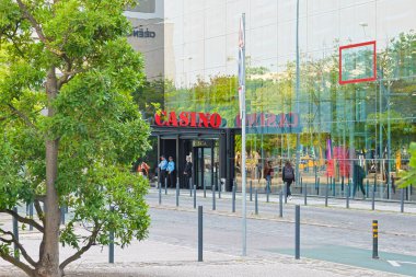 Yeşillik, uluslar parkındaki Lisbon Kumarhanesinin modern girişini çerçeveliyor.