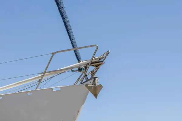 stock image Sailboat bow is showing a furled jib and anchor with blue sky in the background