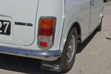 Rear view of a white morris mini hl parked on a parking lot clipart